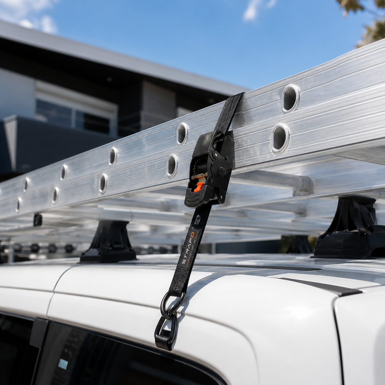 Ladder on a roof rack tied down with a STRAPD strap